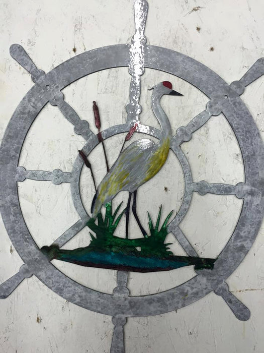 nautical wheel metal wall art with a CRANE